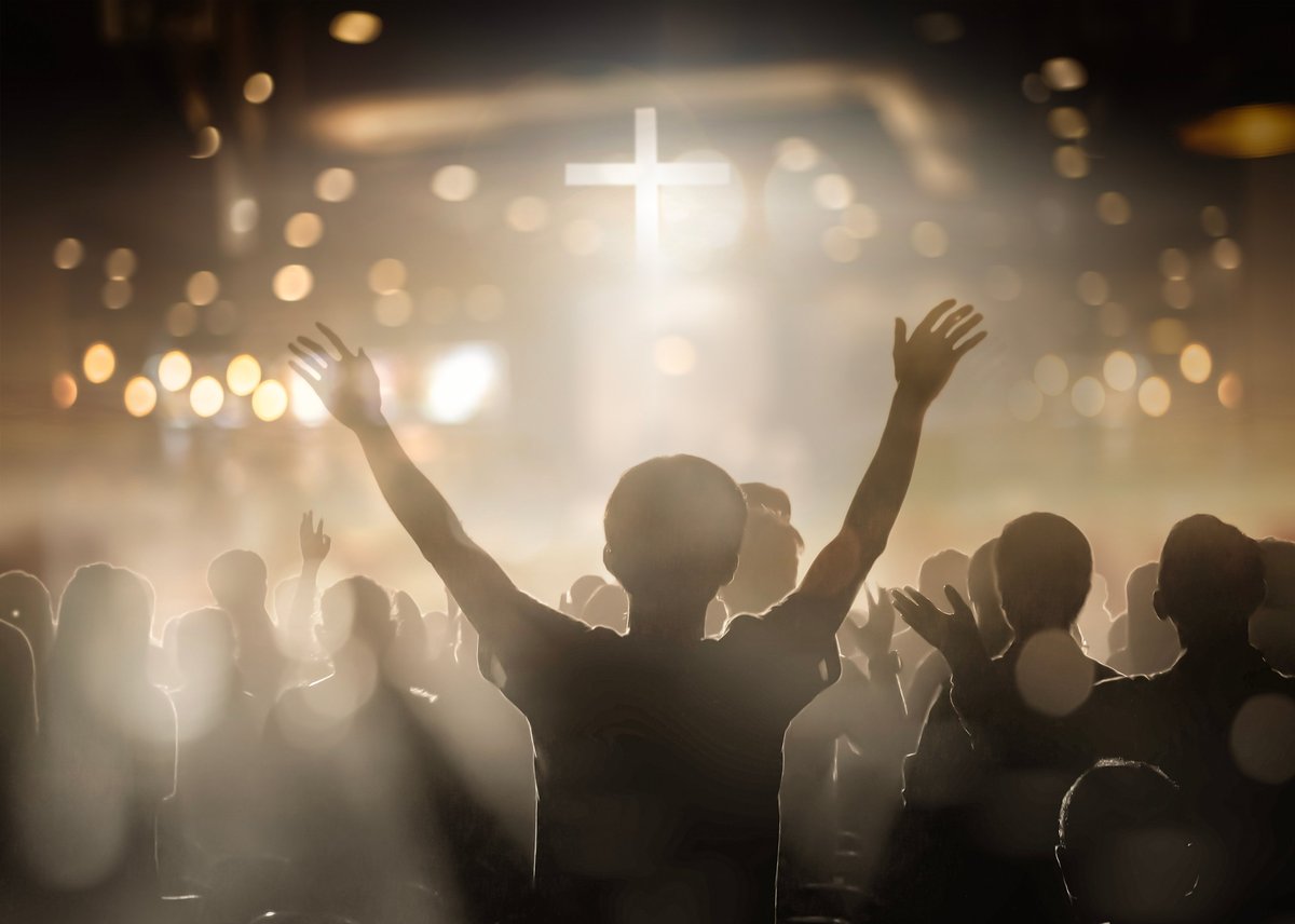 Christians raising their hands in praise and worship at a night music concert. Eucharist Therapy Bless God Helping Repent Catholic Easter Lent Mind Pray. Christian concept background.